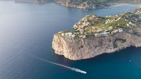 Flying-over-turquoise-water-lagoon-with-seaside-limestone-cliff,-Mallorca