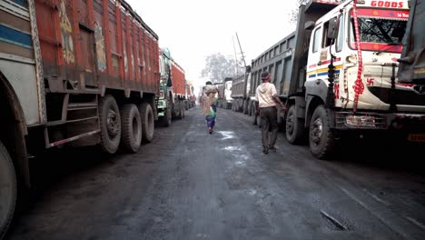 Mine-trucks-used-for-coal-shipment-waiting-for-loading-inside-Jharia-coalfield,-Dhanbad,-Jharkhand