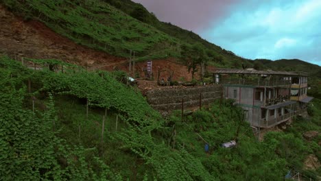 Aerial-view-of-Couple-filming-themselves-on-terraced-hillsides-and-lush-greenery-of-rice-fields-in-Sa-Pa,-Vietnam-captured-by-a-drone