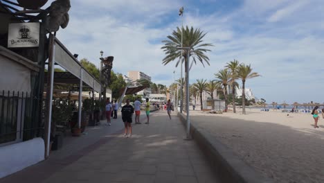 Magaluf-beach-walk-Mallorca,-Spain,-day-time-POV-paved-road,-sand-palm-tree