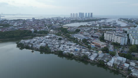 Above-Pluit-Lake-And-Slum-Neighborhoods-In-North-Jakarta-Drone-Rise-and-Rotate