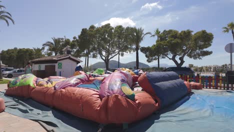 Inflating-a-Giant-Inflatable-Slide,-children-play-area-recreational-park,-Palma-Mallorca