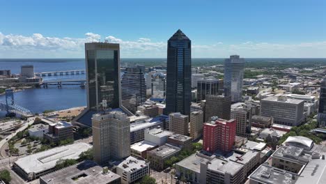 Aerial-establishing-shot-of-downtown-in-Jacksonville-City-during-sunny-day-and-bridges