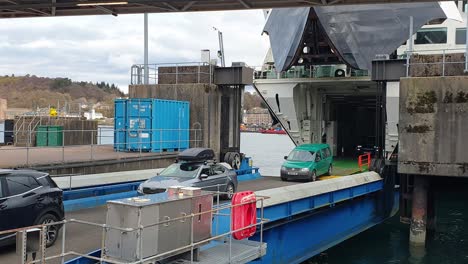 Lines-of-cars-and-vans-disembarking-and-driving-off-Caledonian-Macbrayne-ferry-at-Oban-harbour-in-Scotland-UK