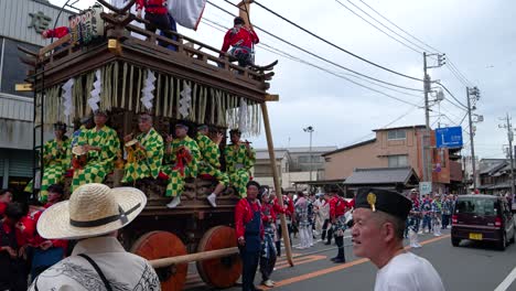 People-carrying-massive-shrines-through-city-of-Sawara