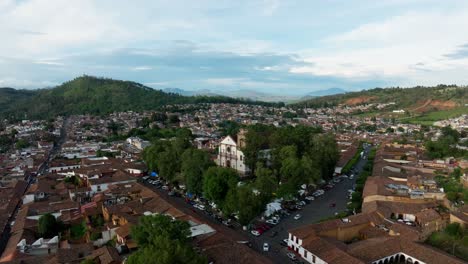 LOW-ALTITUDE-DRONE-DOLLY-SHOT-OF-PATZCUARO-MAIN-CHURCH-AT-SUNSET