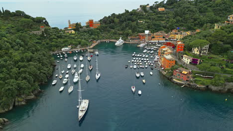 Portofino,-renowned-coastal-town-in-Liguria,-Italy,-features-its-iconic-harbor-filled-with-yachts-and-boats