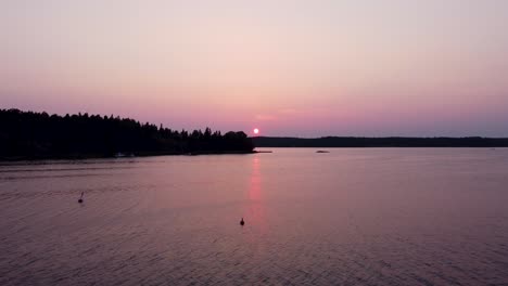 Sunset-by-islands-in-the-Stockholm-Archipelago,-buoys-in-water,-static