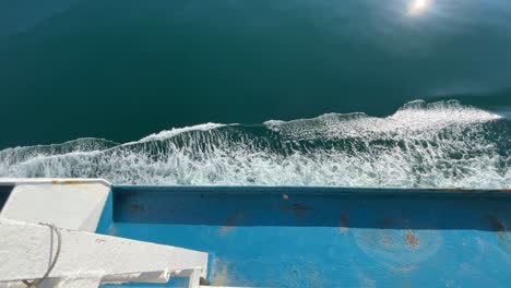 ocean-waves-as-ship-passes-over-a-calm-blue-sea