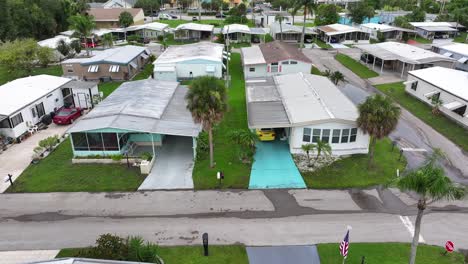 Aerial-flyover-mobile-homes-with-palm-trees-in-suburb-of-Fort-Myers,-Florida