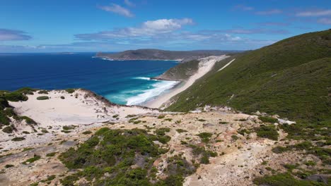 4K-drone-video-flying-over-two-people-hiking-the-Bald-Head-Walking-Trail-within-the-Torndirrup-National-Park-in-Albany,-Western-Australia