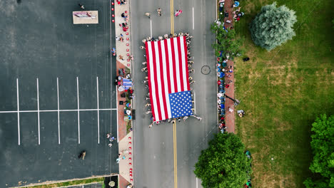 Top-View-Of-American-Flag-Carried-On-Street-During-Fourth-Of-July-Parade-In-Centerville,-Ohio