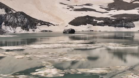 Vista-Aérea-Sobre-La-Superficie-Del-Agua-De-Gletschersee-En-Klausenpass,-Urner-boden,-Suiza,-Mostrando-Klausenpass-Y-El-Lago-Glacial-Griesslisee