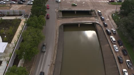 Drone-view-of-under-bridge-flooding-on-Allen-Parkway-in-Houston,-Texas