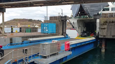 Rows-of-traffic-disembarking-Caledonian-Macbrayne-ferry-docked-at-Oban-harbour-in-Scotland-UK