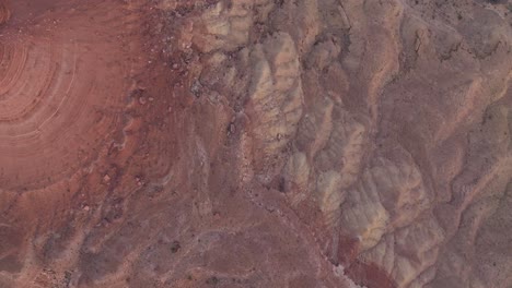 Birds-eye-drone-shot-of-a-canyon-in-the-desert