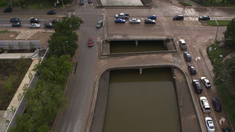 Drone-view-of-under-bridge-flooding-on-Allen-Parkway-in-Houston,-Texas