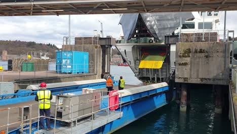 The-door-of-Caledonian-Macbrayne-ferry-slowly-opening-at-Oban-harbour-in-Scotland-UK