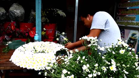 ANTIPOLO-CITY,-PHILIPPINES-–-JULY-12,-2019:-A-flower-shop-worker-prepares-a-bouquet-of-flowers-for-a-customer