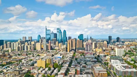 Daytime-hyper-lapse-of-Philadelphia,-PA-from-the-perspective-of-a-bird-as-puffy-clouds-drift-over-the-city