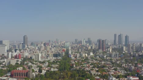 Aerial-dolly-of-Mexico-City-skyline-on-a-clear-day-with-blue-skies
