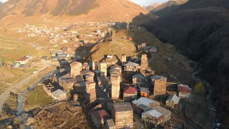 Aerial-view-of-a-rural-village-in-a-valley-in-the-Svaneti-region,-Georgia,-with-many-Svan-Towers-built-in-the-centre-of-the-town