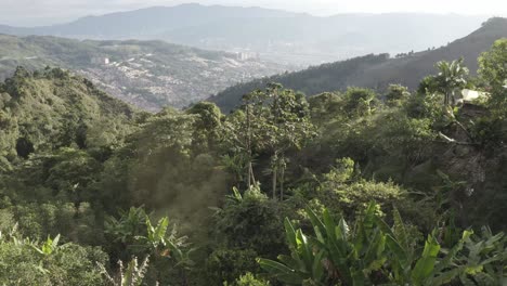 Vista-Ascendente-De-Las-Montañas-Con-Medellín,-Colombia-Al-Fondo