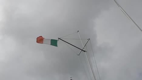 Irish-Flag-in-the-wind-on-a-boat's-flag-pole-on-an-overcast-day-Ireland