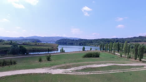 Ascending-aerial-view,-revealing-lakes-in-a-small-valley-in-the-Tuskany-in-Italy