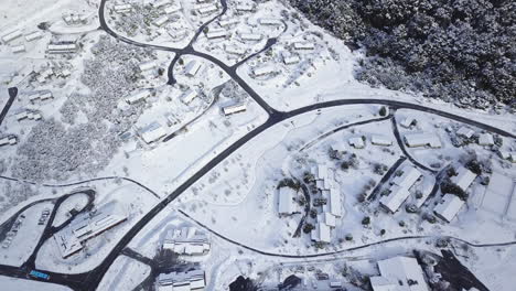 Aerial-Shot-of-a-Snowy-town-with-snow-covered-roads