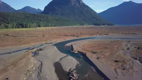 Aerial-flight-over-shallow-streams-that-don't-carry-enough-water-to-form-a-lake-as-not-enough-snow-grew-on-local-mountains-that-feed-Ross-lake