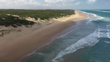 Pull-Away-Aerial-Shot-of-Vast-Chidenguele-Endless-Beach-in-Mozambique