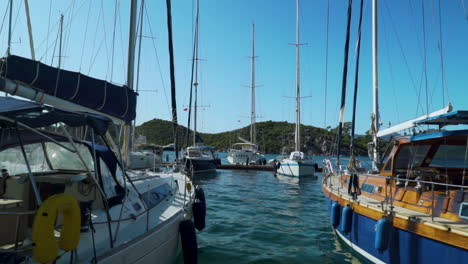 This-shot-depicts-a-calm-view-by-the-seaside-in-Turkey,-Marmaris-with-a-backdrop-to-some-boats-and-mountains