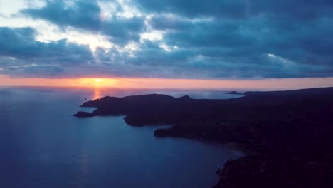 AERIAL:-view-of-sunset,-ocean-and-islands