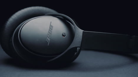 Headphone-Bose-on-black-background,-the-camera-moves-from-left-to-right