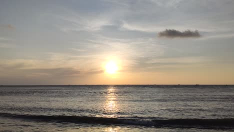 A-dolly-shot-of-a-beautiful-sun-setting-over-the-sea-in-fort-kochi,-with-clear-skies-and-low-tides