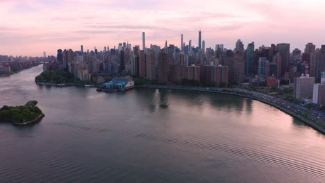 Aerial-footage-lands-looking-ahead-to-Manhattan,-NYC-over-the-water