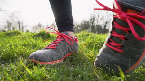 Female-Runner-Warms-Up-and-Rolls-Ankles-Before-a-Jog