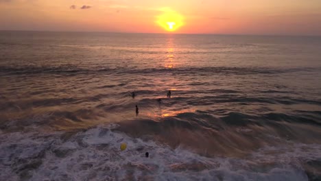 Drohnenvideo-Eines-Surfers,-Der-Vom-Brett-Fällt-Und-Bei-Sonnenuntergang-Am-Strand-Von-Canggu-In-Bali,-Indonesien,-Auf-Einer-Welle-Reitet