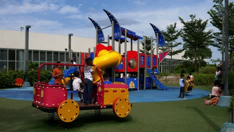 Supervised-by-parents-and-guardians,-frolicking-young-kids-explore-the-playground-attractions-at-SM-Seaside-Mall-on-South-Road-Properties,-Cebu-City,-Philippines