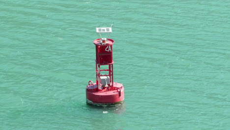 Red-buoy-in-aqua-ocean-water-near-Juneau-Alaska