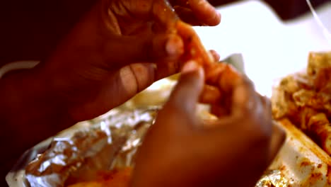 Extreme-closeup-of-Young-black-woman-eating-freshly-cooked-crablegs