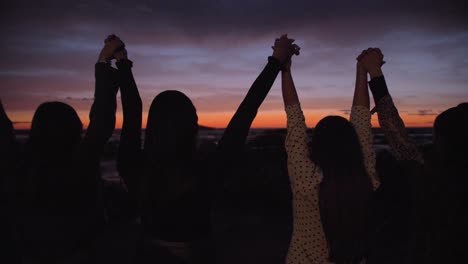 Friends-Hold-Hands-at-the-Beach-4K