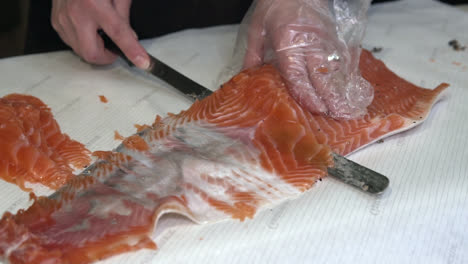 cutting-salmon-in-thin-layers-with-knife,-slow-motion-1080p