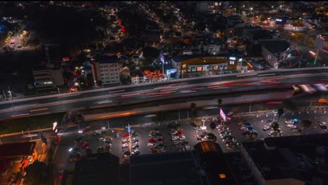 Flight-with-drone-in-the-city-at-night-during-traffic-hour,-4k