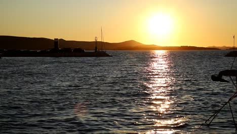 Boats-and-yachts-enter-and-exit-marina-at-sunset-in-Biograd-in-Croatia-speed-up