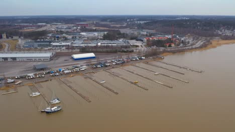 Aerial-view-on-a-cloudy-day-panning-right-around-the-almost-empty-Pansio-small-boat-marina