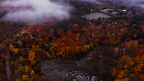 Beautiful-mountain-house-surrounded-by-thick-forest---Fall-foliage-in-Green-mountain-Vermont---Aerial-Drone-4k-footage