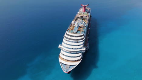 Drone-shot-around-the-Carnival-dream-voyager-anchored-on-the-Caribbean-ocean