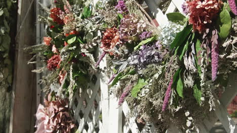 Wreaths-for-sale-at-street-festival-in-Lewisburg,-Pennsylvania,-Lift-Up-Slow-Motion